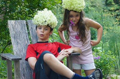 Kids being silly with flowers on their heads in the gardens